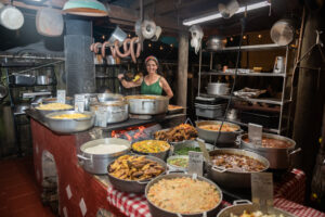 Regina of Regina's Farm with prepared foods for Broward College Night at Regina's Farm.